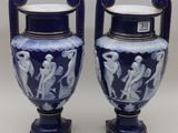 pair of blue and white vases sitting on top of a table