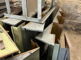 a pile of metal and wood in a room with a ladder