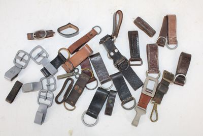 many different types of leather key chains on a white surface