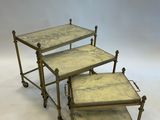 a set of three brass and marble nesting tables