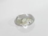 a close up of a white diamond on a white surface