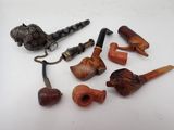 many different types of smoking pipes on the table