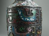 a vase that has a dragon design on the side of it