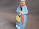 a figurine of a man with a top hat and tie