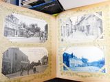 a book opened to show old photos of a town