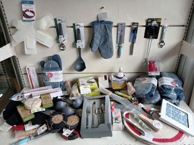 a counter top with various kitchen items and utensils on it