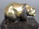 a bronze statue of a bear on a marble base