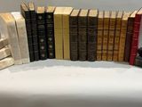 a lot of books that are stacked up on a table