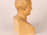 marble bust of a young boy with a short haircut