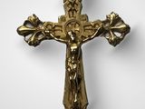 a close up of a cross on a wall with a white background