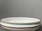 a white bowl with a red stripe on it