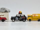 several toy cars are lined up in a row on a white surface