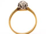 a close up of a diamond ring on a white background
