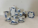 a lot of blue and white dishes and cups on the table