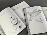two pages of a book with a drawing of a man and a plane