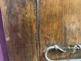 a close up of a wooden door with a latch
