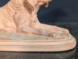 a statue of a dog that is sitting on a table