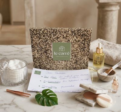the contents of a spa package are laid out on a marble table