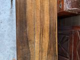 a wooden cabinet with a mirror on it next to a window