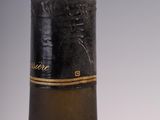 an old bottle of wine sitting on top of a table