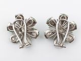 pair of silver tone flower clip earrings on a white background