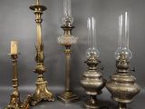 four different types of candles and a candle holder on a table