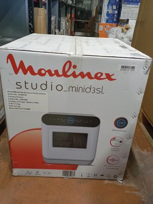 the box of the microwave is sitting on the table in the room