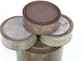 several tins of paint are stacked on top of each other