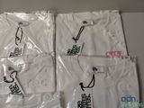 four white t - shirts with chinese writing on them sitting on a table
