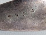 a close up of a knife on a white surface