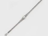 a close up of a silver bracelet on a white background