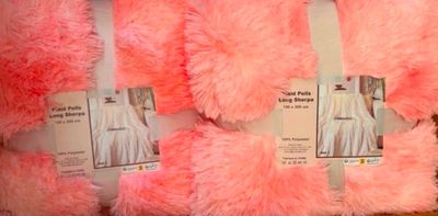 several pink teddy bears are on display in a store
