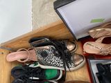 many pairs of shoes that are sitting on the floor