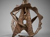 a close up of a sculpture on a table with a gray background