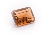 a square faceted brown diamond on a white background