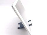 a tablet computer sitting on a stand on a table