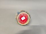 a close up of a red and white object on a table