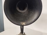 a very old black speaker that is on a table
