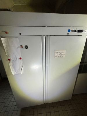 a white refrigerator that has a lot of magnets on it