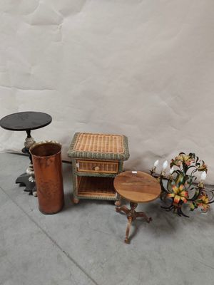 a small table with a basket on top of it next to a vase with flowers