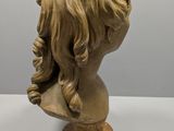 a close up of a statue of a woman ' s head with long hair