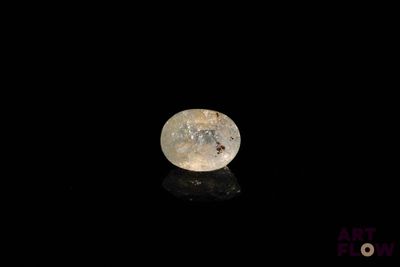 a close up of a white diamond on a black surface