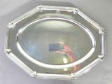 a person taking a picture of a silver plate