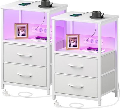 pair of white nightstands with purple lighting and pictures on them