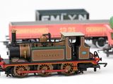three toy trains that are sitting on a white surface