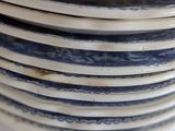 a stack of blue and white plates stacked on top of each other