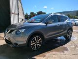 nissan qx - v in a parking lot in front of a building