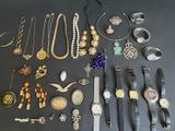 many different types of jewelry on display on the table
