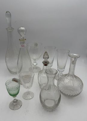 a lot of glass vases and glasses on the table