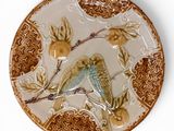 a decorative plate with a bird on it on a white background